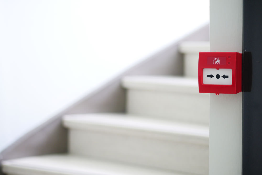 Red fire alarm button on wall ,